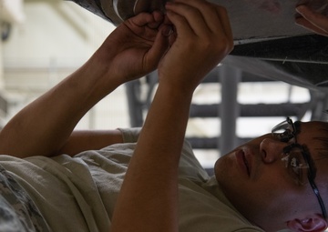 Multi-unit fuel system specialists team changes C-130 auxiliary fuel cell