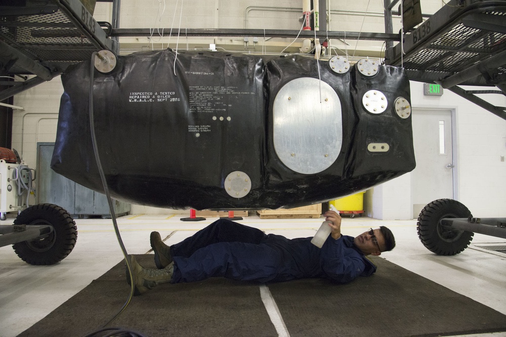 Multi-unit fuel system specialists team changes C-130 auxiliary fuel cell