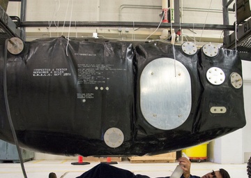 Multi-unit fuel system specialists team changes C-130 auxiliary fuel cell