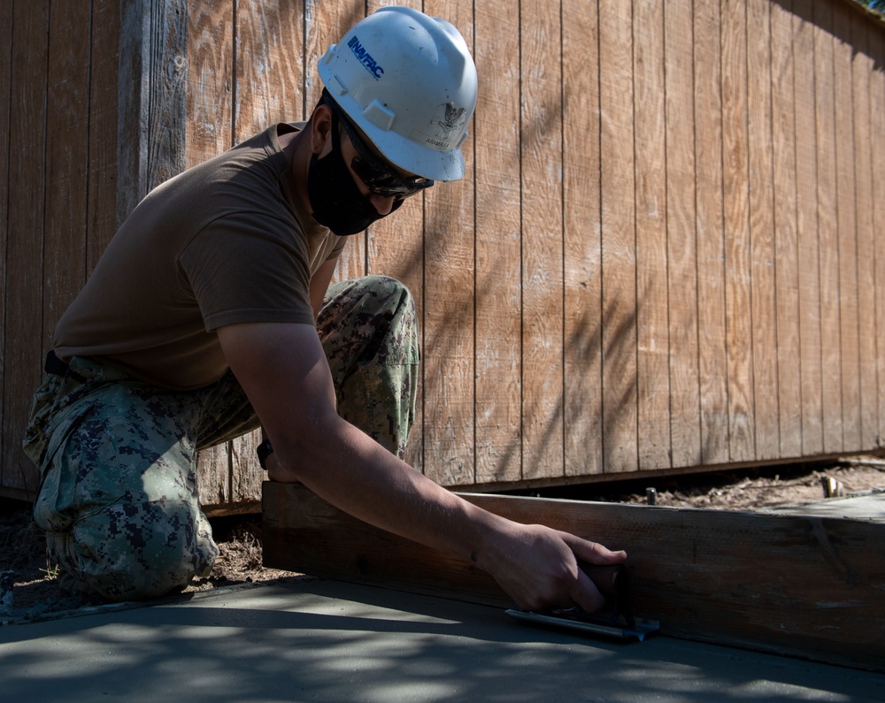 Seabees lay concrete for ADA sidewalk
