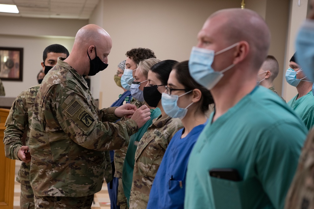 U.S. Army Lt. Col. Jason Hughes, commander, Urban Augmentation Medical Task Force - 627 presents awards at Baptist Medical Center