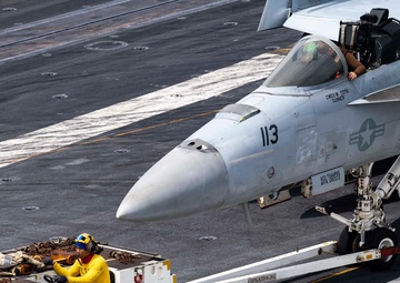 Sailors Taxi An F/A-18F Super Hornet Across The Flight Deck Aboard Nimitz