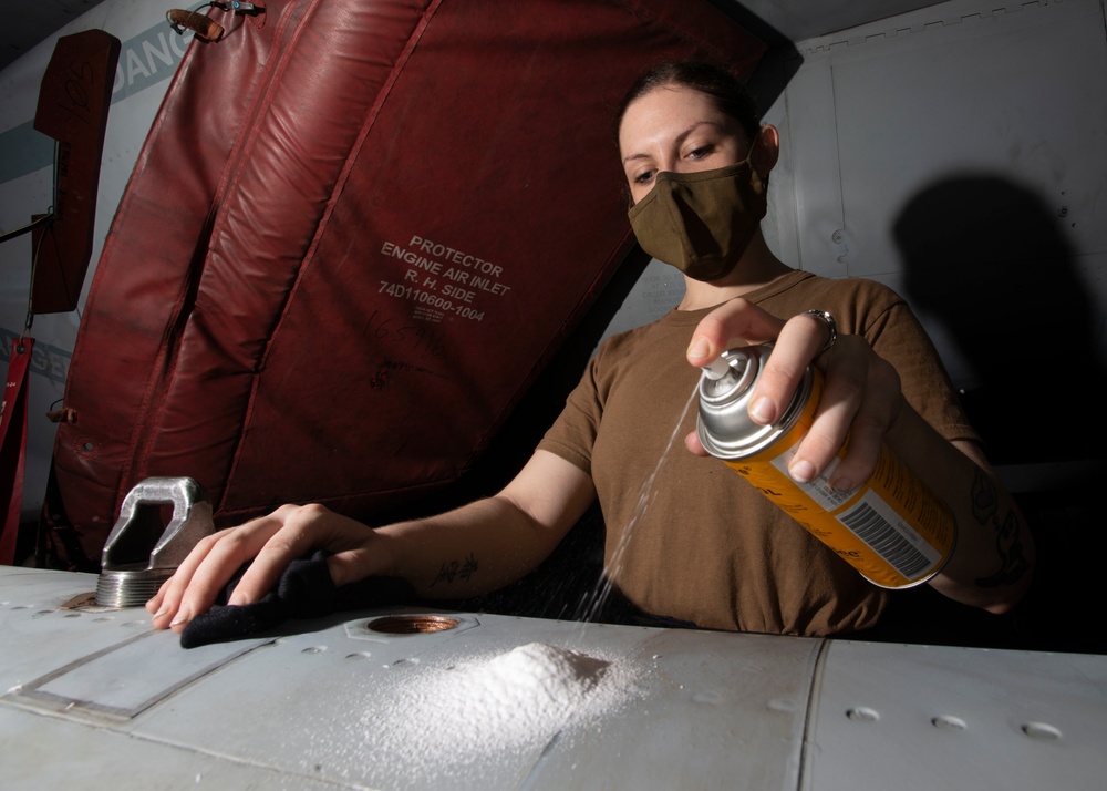 Aviation Electronics Technician Uses Scrubby Bubbles To Clean Jamming Pod Of An F/A-18G Growler, from the &quot;Cougars&quot; Of Electronic Attack Squadron (VAQ) 139, In Hangar Bay Aboard Aircraft Carrier USS Nimitz CVN 68