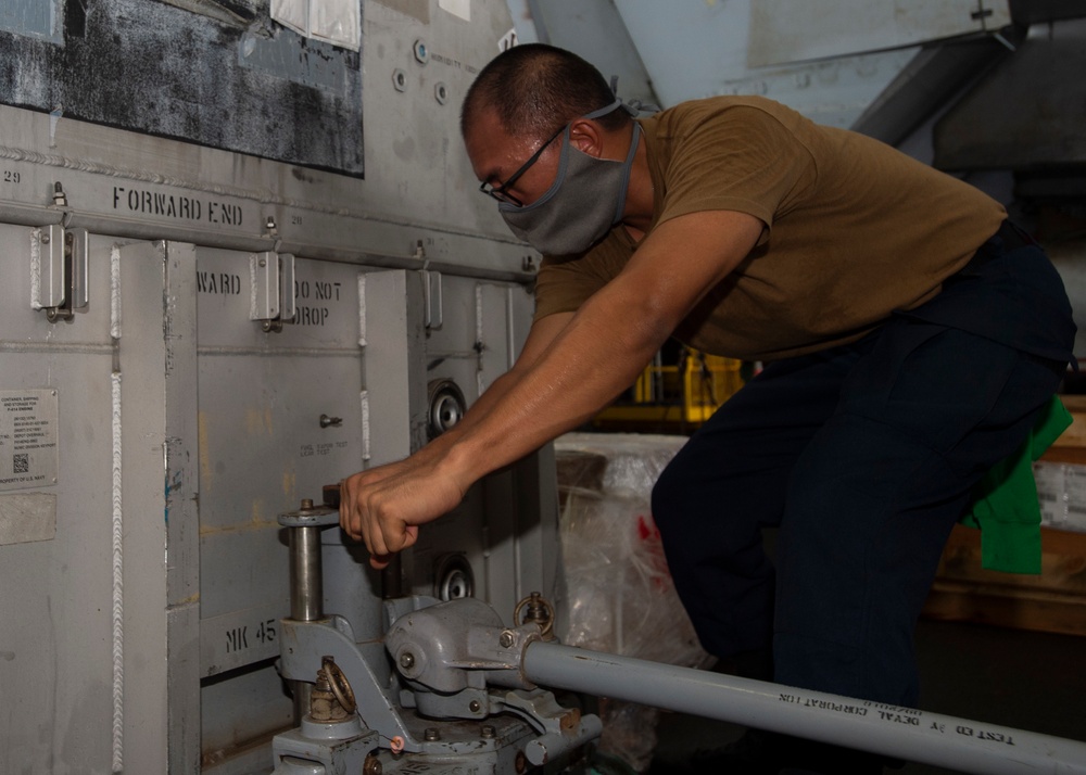 Sailor Tightens Jack For Engine Container Movement