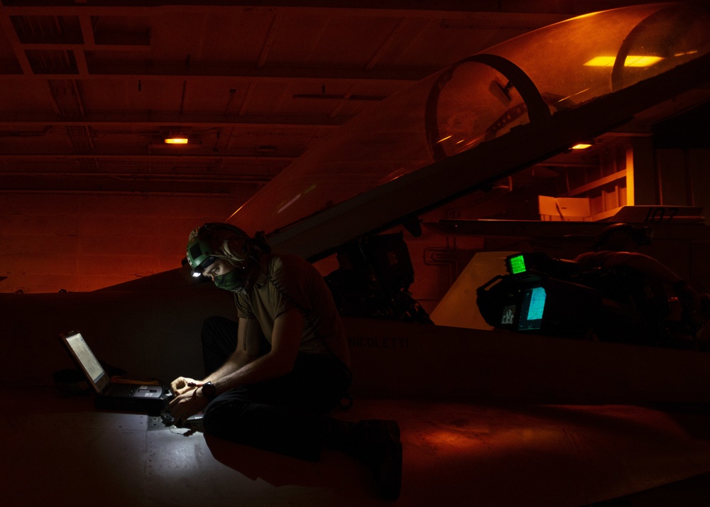 Aviation Electronics Technician Reads Out Wires For Data Link On An F/A-18F Super Hornet, from the &quot;Mighty Shrikes&quot; of Strike Fighter Squadron (VFA) 94, In Hangar Bay Aboard Aircraft Carrier USS Nimitz CVN 68