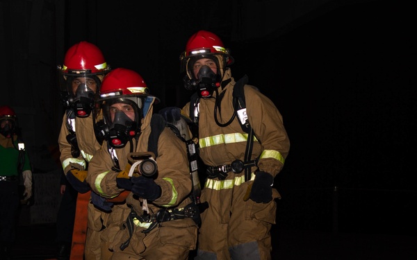 Sailors conduct firefighting training during a General Quarters drill in the hangar bay of the aircraft carrier USS Nimitz (CVN 68)
