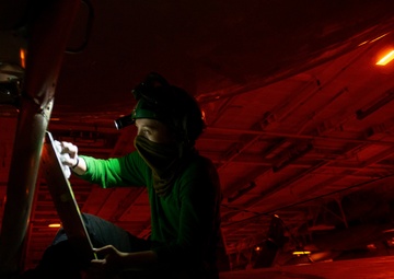 Aviation Structural Mechanic Performs Corrosion Prevention Maintenance On E-2C Hawkeye, From &quot;Sun Kings&quot; Of Carrier Airborne Early Warning Squadron (VAW) 116, In Hangar Bay Aboard Aircraft Carrier USS Nimitz CVN 68