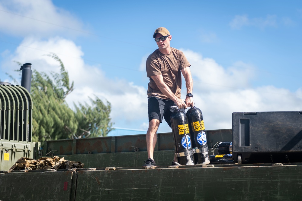 Underwater Construction Team 2 Unloads Gear in Tinian