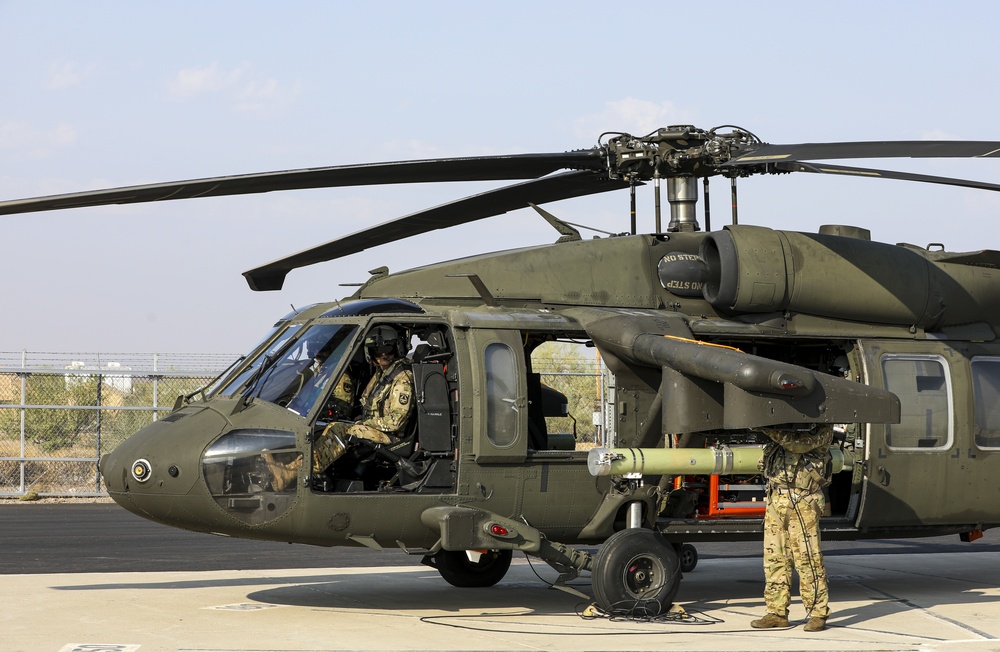 An Air Launched Effects (ALE) system is loaded onto a UH-60L Black Hawk as capabilities testing commences during Project Convergence, at Yuma Proving Ground, Arizona, September 15, 2020.