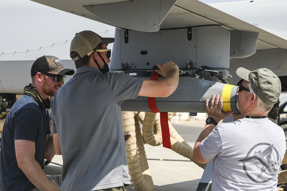 A payload is loaded onto an Extended Range / Multipurpose (ER/MP) Unmanned Aircraft System (UAS), for capabilities testing during Project Convergence 20 at Yuma Proving Ground, Arizona, September 15, 2020.