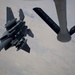 A U.S. Air Force KC-135 Stratotanker refuels F-15E Strike Eagles