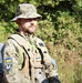 A Ukrainian soldier stands in front of a vehicle during Combined Resolve