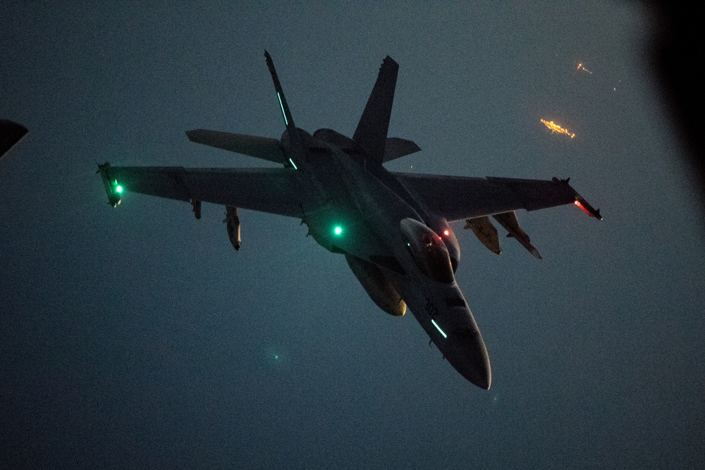 U.S. Navy F/A-18E Super Hornet is refueled by U.S. Air Force KC-135