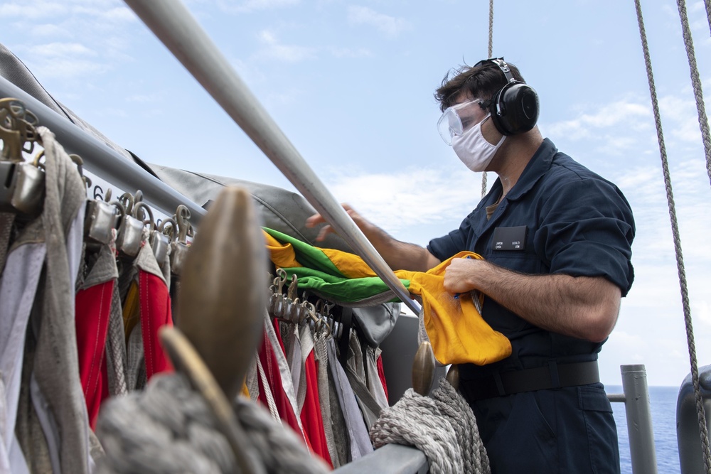 USS America Quartermaster Organizes Signal Flags