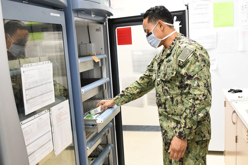 Navy Medicine Readiness and Training Command Sailor Opens Vaccination Refrigerator
