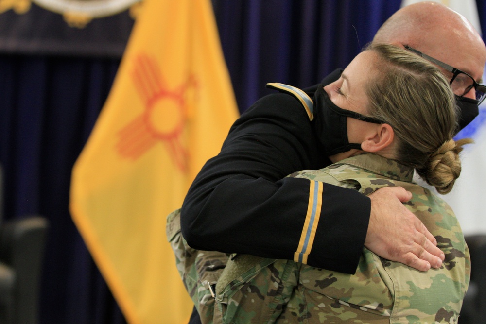 Stark hugs colleague (200911-Z-YU904-1545)