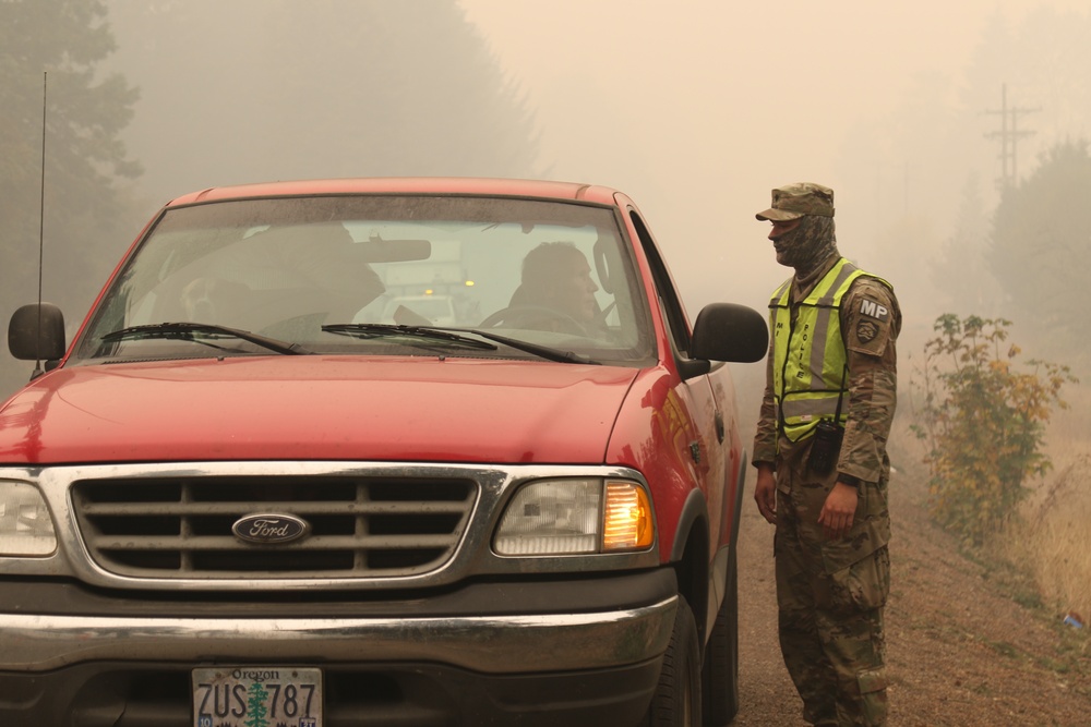 Oregon Army National Guard Soldiers man traffic control points to protect citizens from fire hazards