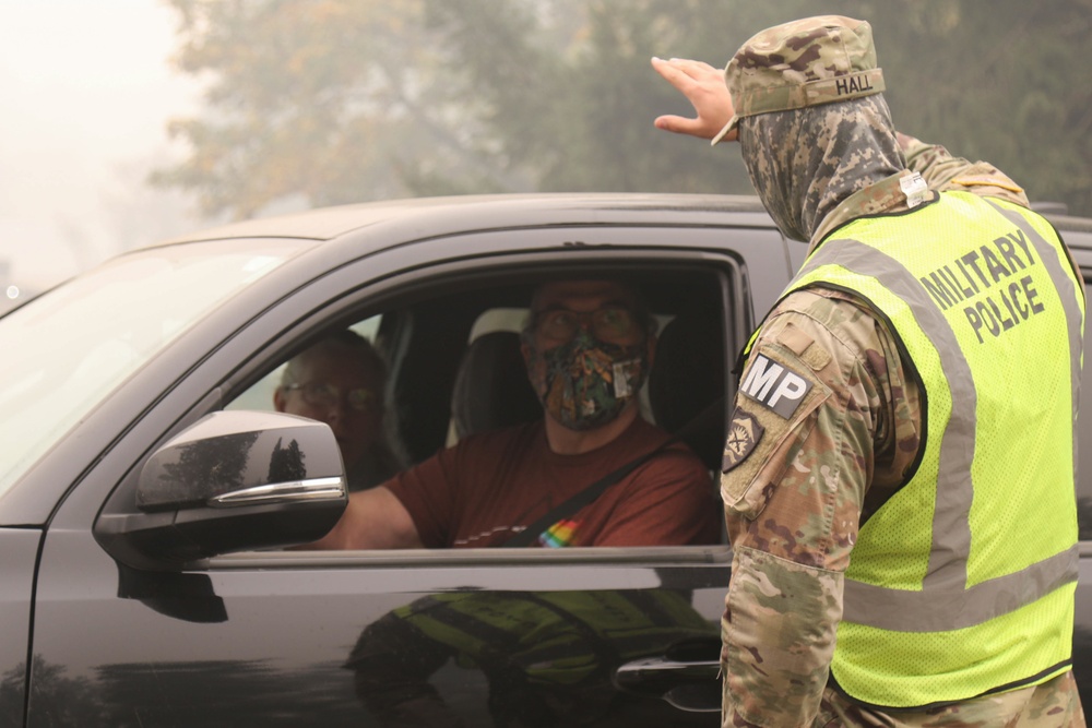 Oregon Army National Guard Soldiers man traffic control points to protect citizens from fire hazards