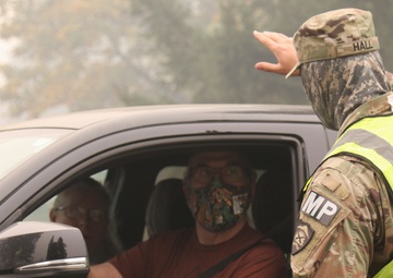 Oregon Army National Guard Soldiers man traffic control points to protect citizens from fire hazards