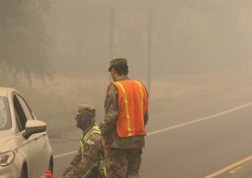 Oregon Army National Guard Soldiers man traffic control points to protect citizens from fire hazards