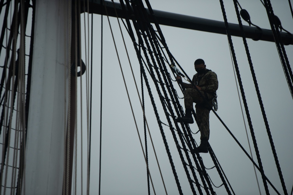 Sailors climb the shrouds aboard USS Constitution