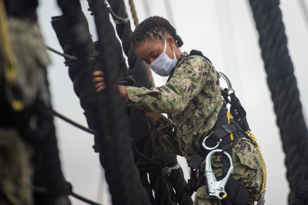 Sailors climb the shrouds aboard USS Constitution