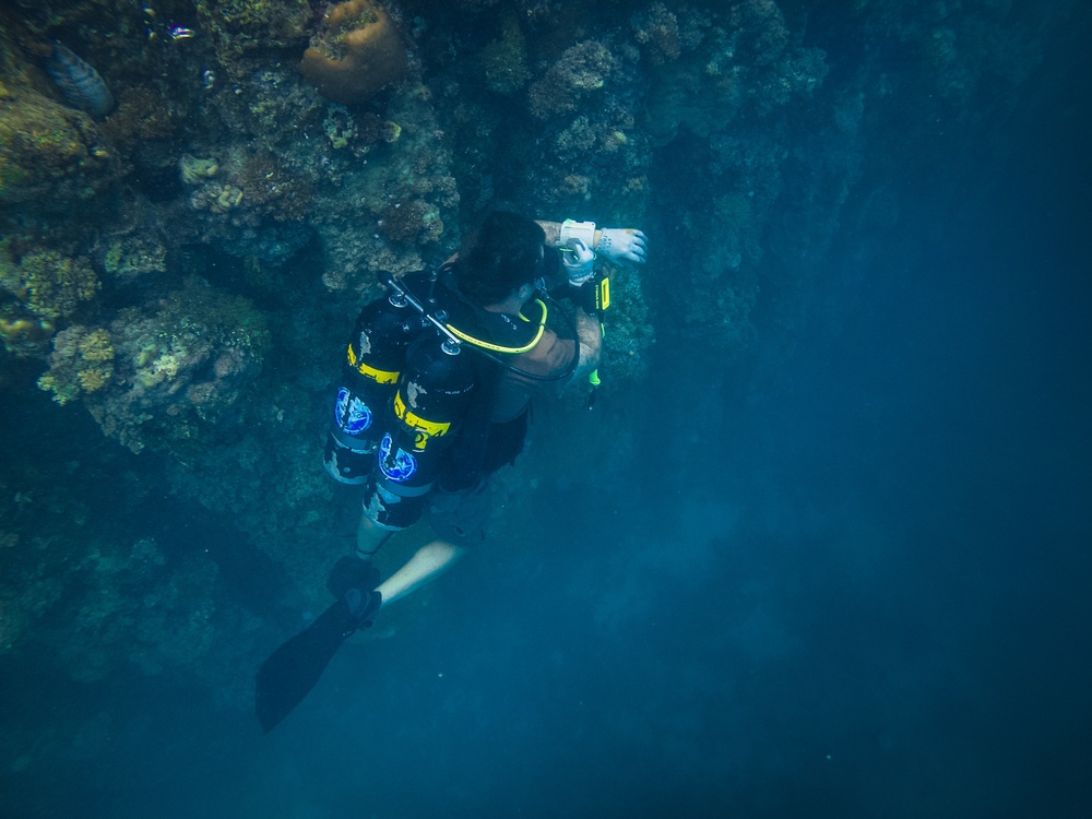 Navy Seabee Divers Inspect Pier in CNMI