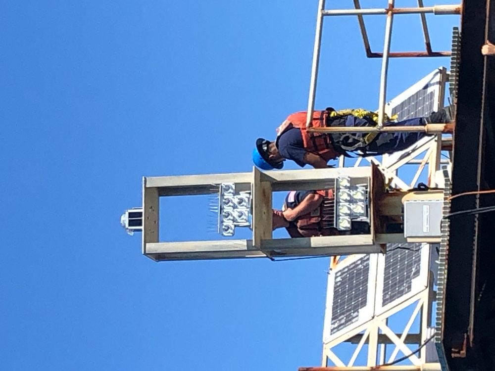 Coast Guard aids to navigation crew members repair navigation lights in Mobile, Alabama Channel