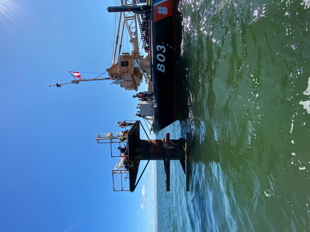 Coast Guard aids to navigation crew members repair navigation lights in Mobile, Alabama Channel