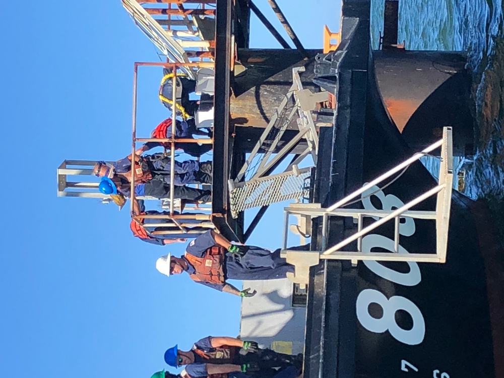 Coast Guard aids to navigation crew members repair navigation lights in Mobile, Alabama Channel