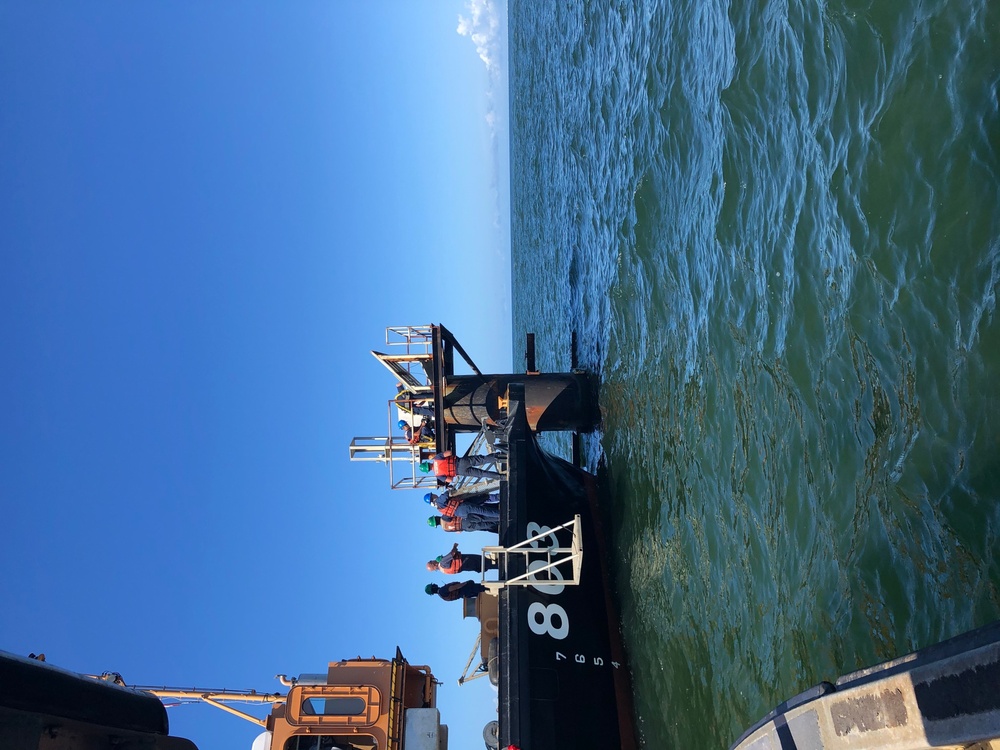 Coast Guard aids to navigation crew members repair navigation lights in Mobile, Alabama Channel