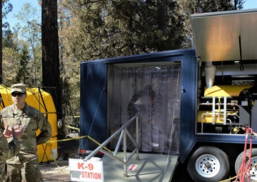 Dog tags and wags: Soldiers decontaminate search and rescue volunteers near North Complex Fire