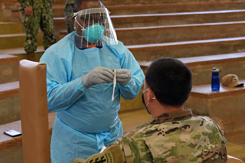 NMRTC-PH Sailor explains COVID-19 swab procedure to U.S. Army Soldier