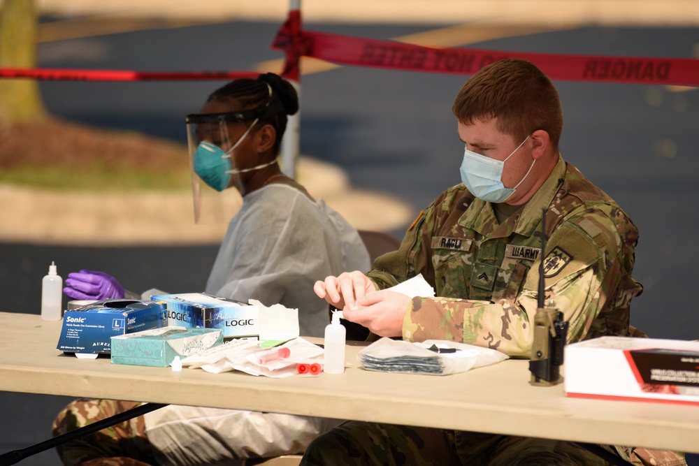 Michigan National Guard soldiers work side-by-side with members of the Wayne County Health Department
