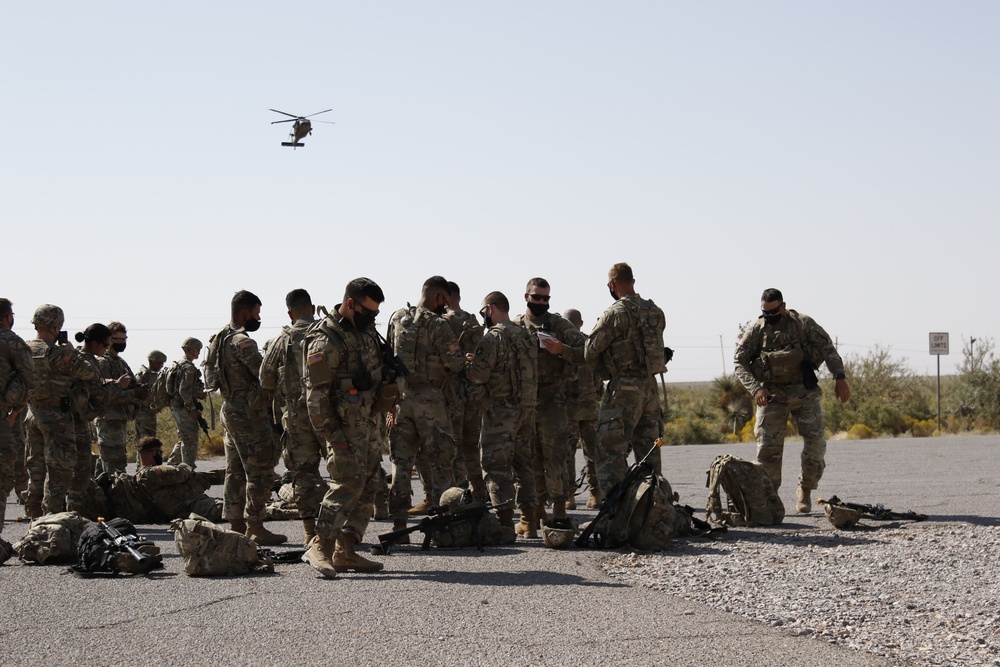 1-113th Soldiers move by Blackhawk