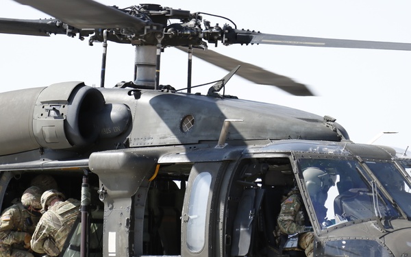 1-113th Soldiers move by Blackhawk