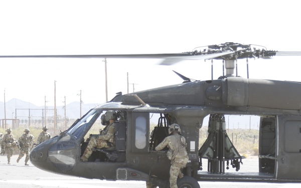 1-113th Soldiers move by Blackhawk