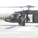 1-113th Soldiers move by Blackhawk