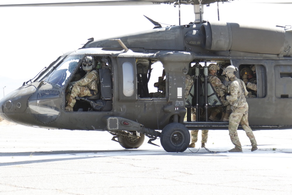 1-113th Soldiers move by Blackhawk