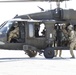 1-113th Soldiers move by Blackhawk