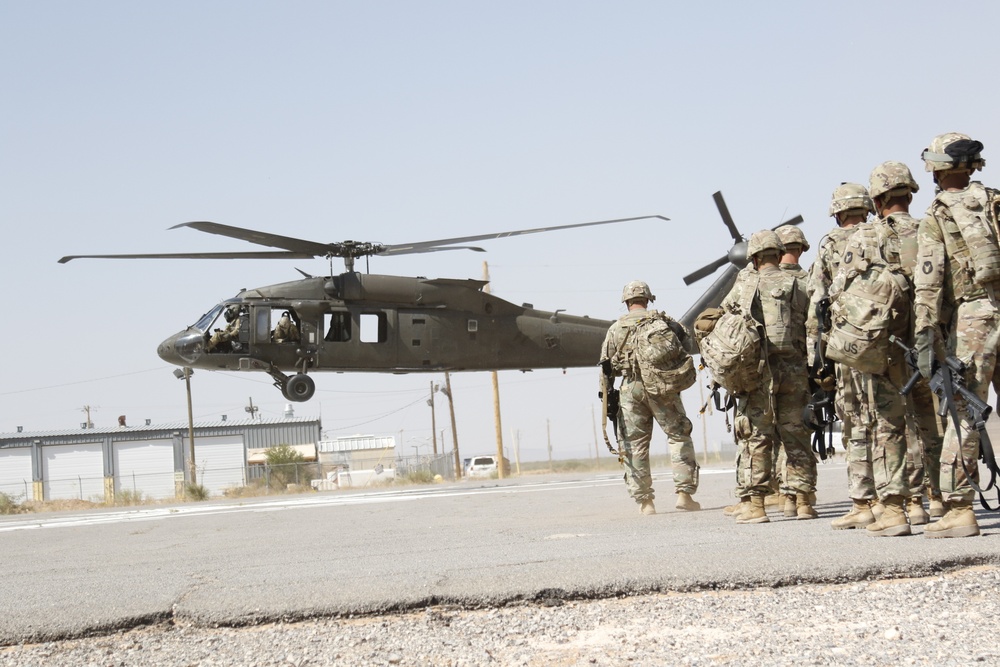 1-113th Soldiers move by Blackhawk