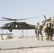 1-113th Soldiers move by Blackhawk