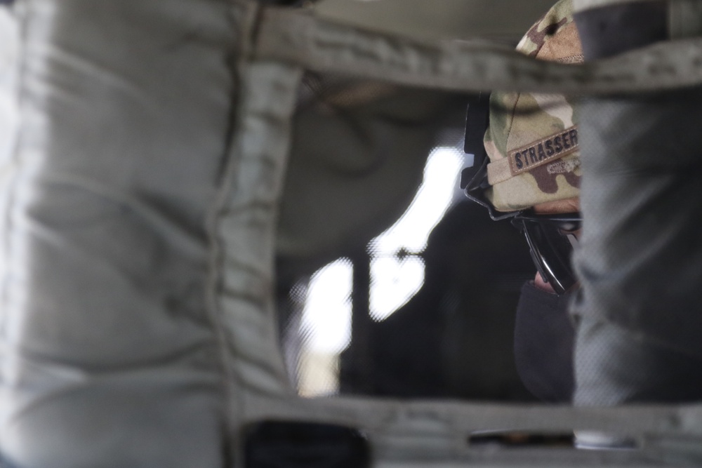 1-113th Soldiers move by Blackhawk