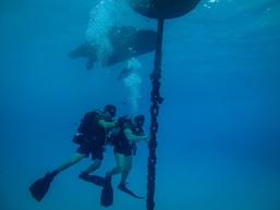 Navy Seabee Divers Inspect Pier in CNMI