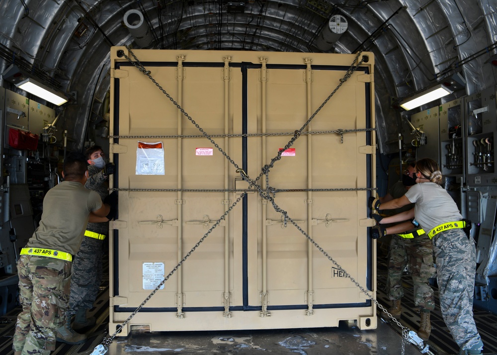 Airmen on-load a collectively protected CONNEX onto a C-17 Globemaster III