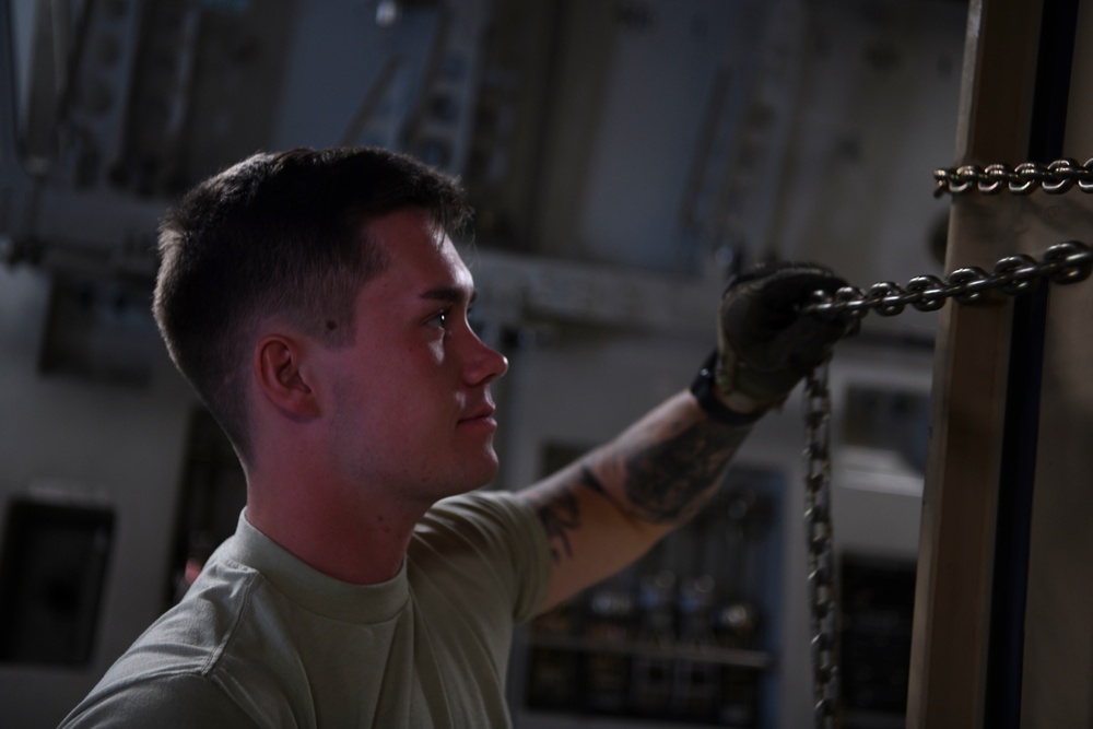 A1C Camron Palmer conducts qualification training on a CONNEX on a C-17 Andersen AB, Guam