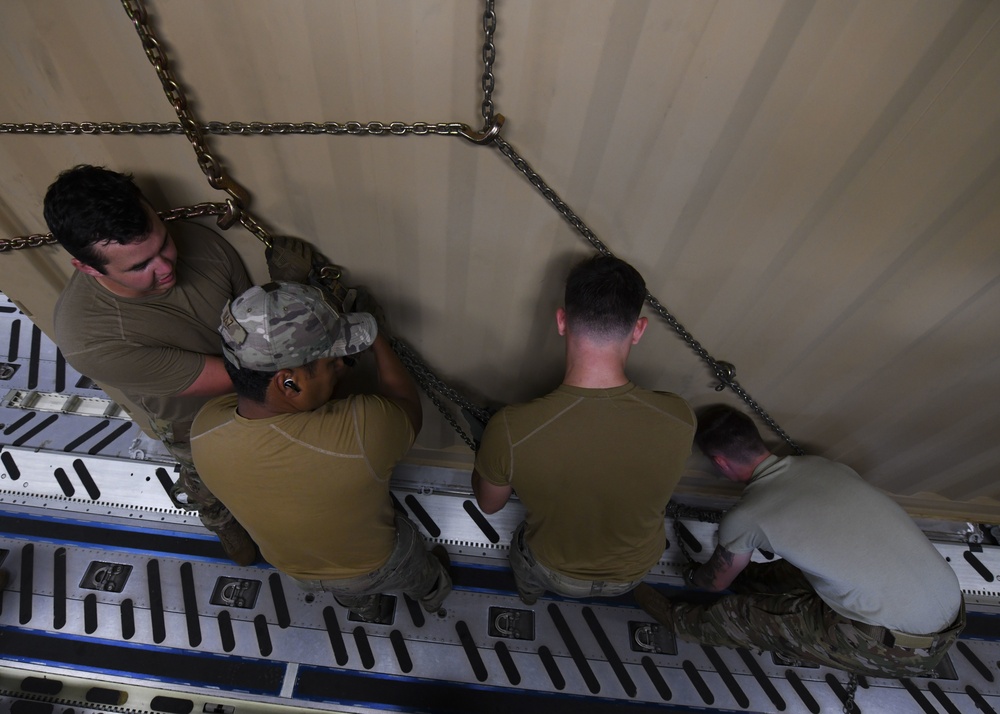 Loadmasters conduct qualification training on a CONNEX, at Andersen AB, Guam