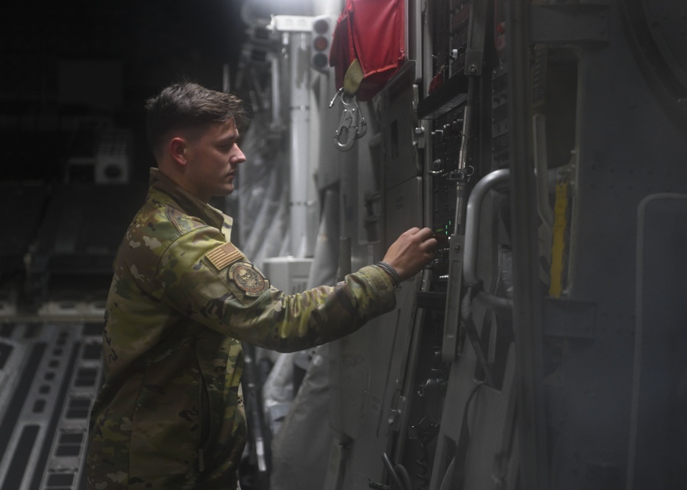 Staff Sgt. Carmen O’Donnel closes a C-17 cargo bay door