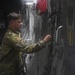 Staff Sgt. Carmen O’Donnel closes a C-17 cargo bay door