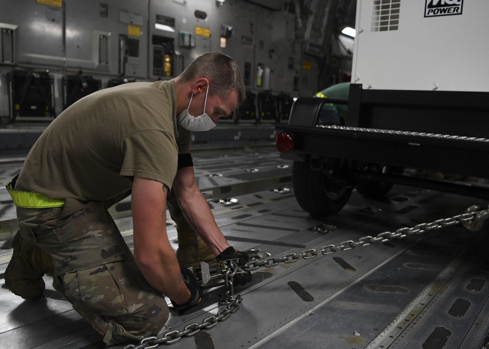 Senior Airman Zachary Richter on-loads a mobile field hospital onto a C-17
